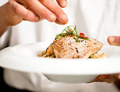 Chef adding final touch to tuna appetizer