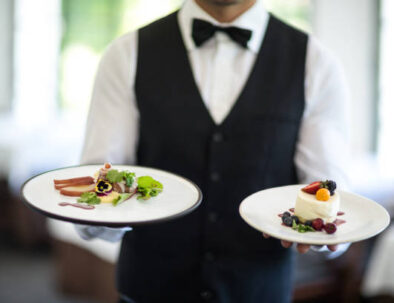 Waiter showing a dish in a commercial kitchen