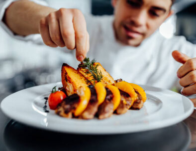 Shot of a young chef decorating meal in the kitchen